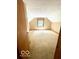 Slanted ceilings add charm to the carpeted bedroom with a single window at 4419 Liberty Loop Rd, Martinsville, IN 46151