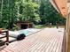 Wooden deck with a hot tub and serene views of the surrounding woods at 4419 Liberty Loop Rd, Martinsville, IN 46151