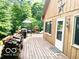 Wooden deck with ample seating offering serene views of the surrounding woods at 4419 Liberty Loop Rd, Martinsville, IN 46151