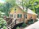 Charming tan home exterior with a large front yard, deck, and mature trees for shade at 4419 Liberty Loop Rd, Martinsville, IN 46151
