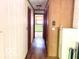Hallway with wood floors and wood paneling, leading to the bedrooms at 4419 Liberty Loop Rd, Martinsville, IN 46151