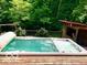 Large outdoor hot tub surrounded by lush green trees, creating a private and relaxing space at 4419 Liberty Loop Rd, Martinsville, IN 46151