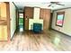 Living room featuring hardwood floors, wood paneling, and a fireplace at 4419 Liberty Loop Rd, Martinsville, IN 46151