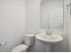 Half bathroom featuring a pedestal sink, toilet, and mirror at 4785 E Shadowbrook Dr, Camby, IN 46113