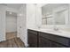 Bathroom with dual sinks, dark wood cabinets, a large mirror, and a walk-in closet at 4785 E Shadowbrook Dr, Camby, IN 46113