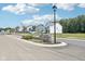 Welcoming entrance to Allison Estates, featuring a stone sign, manicured landscaping, and well-maintained roads at 4785 E Shadowbrook Dr, Camby, IN 46113