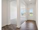 Inviting foyer with hardwood floors, white columns, and views of a carpeted living space at 4785 E Shadowbrook Dr, Camby, IN 46113