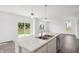 Bright kitchen island featuring a double sink, stainless steel dishwasher, and pendant lighting at 4785 E Shadowbrook Dr, Camby, IN 46113