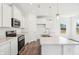 Modern kitchen featuring stainless steel appliances, white cabinetry, and a marble countertop at 4785 E Shadowbrook Dr, Camby, IN 46113