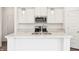 Contemporary kitchen with white cabinetry, marble countertops, and modern fixtures at 4785 E Shadowbrook Dr, Camby, IN 46113
