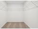 Spacious walk-in closet featuring carpeted floors and extensive wire shelving for optimal storage solutions at 4785 E Shadowbrook Dr, Camby, IN 46113