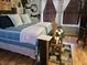 Relaxing bedroom with a comfortable bed, soft blue bedding, natural light, and stylish decorative accents at 4962 Potomac Square Pl, Indianapolis, IN 46268