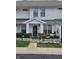 Charming two-story townhouse with well-maintained lawn, landscaping, and front porch decor at 4962 Potomac Square Pl, Indianapolis, IN 46268