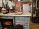 Charming kitchen with white cabinets, stainless steel appliances, and a decorative bar with rustic wood paneling at 4962 Potomac Square Pl, Indianapolis, IN 46268