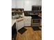 Modern kitchen featuring stainless steel appliances, white cabinets, and a practical layout at 4962 Potomac Square Pl, Indianapolis, IN 46268