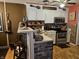 Well-lit kitchen featuring stainless steel appliances, white cabinets, and a cozy breakfast bar with counter seating at 4962 Potomac Square Pl, Indianapolis, IN 46268