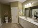 Well-lit bathroom with a large mirror, a marble countertop vanity, and a framed piece of art at 5486 Lipizzan Ln, Plainfield, IN 46168