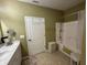 Bathroom featuring shower/tub combo, vanity with marble countertops, and tan walls at 5486 Lipizzan Ln, Plainfield, IN 46168