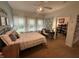 Comfortable bedroom with a ceiling fan, an adjoining desk, and lots of natural light from three windows at 5486 Lipizzan Ln, Plainfield, IN 46168