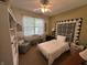 Cozy bedroom with ceiling fan, a white bed, bookshelves, and decor at 5486 Lipizzan Ln, Plainfield, IN 46168