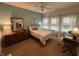 Cozy bedroom featuring a double bed, ceiling fan, and natural light from the three windows at 5486 Lipizzan Ln, Plainfield, IN 46168
