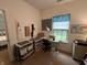 A craft room featuring a work table in front of a window and an adjacent sewing table at 5486 Lipizzan Ln, Plainfield, IN 46168