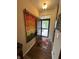 Entryway foyer with wood flooring, a colorful rug, and an open front door at 5486 Lipizzan Ln, Plainfield, IN 46168
