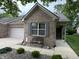 Charming brick home featuring a cozy front porch with a decorative bench at 5486 Lipizzan Ln, Plainfield, IN 46168