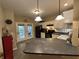 Well-lit kitchen featuring white cabinets, black appliances, and a large island at 5486 Lipizzan Ln, Plainfield, IN 46168