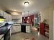 Traditional kitchen featuring white cabinets, black appliances, and a breakfast bar open to the living area at 5486 Lipizzan Ln, Plainfield, IN 46168