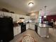 Traditional kitchen featuring white cabinets, black appliances, and a breakfast bar overlooking the living area at 5486 Lipizzan Ln, Plainfield, IN 46168