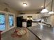 Stylish kitchen with white cabinets, black appliances, and access to the patio at 5486 Lipizzan Ln, Plainfield, IN 46168