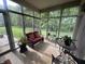 Relaxing screened porch with comfortable seating and views of the lush backyard at 5486 Lipizzan Ln, Plainfield, IN 46168