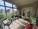 Relaxing screened porch with comfortable seating and views of the lush backyard at 5486 Lipizzan Ln, Plainfield, IN 46168
