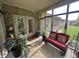 Relaxing screened porch with comfortable seating and views of the lush backyard at 5486 Lipizzan Ln, Plainfield, IN 46168