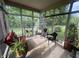 Relaxing screened porch with comfortable seating and views of the lush backyard at 5486 Lipizzan Ln, Plainfield, IN 46168