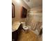 Bathroom with a shower-tub combo with gold framed sliding doors at 5601 Milhouse Rd, Indianapolis, IN 46221