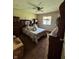 Bedroom featuring hardwood furniture, a ceiling fan, and a plush, comfortable bed at 5601 Milhouse Rd, Indianapolis, IN 46221