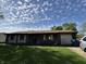 Single story brick home with attached garage featuring a well maintained lawn at 5601 Milhouse Rd, Indianapolis, IN 46221