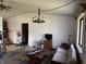 Spacious living room with rustic chandelier and a large window allowing for plenty of natural light at 5601 Milhouse Rd, Indianapolis, IN 46221