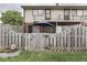 Fenced backyard with a patio and umbrella and upper level deck, providing a relaxing outdoor space at 57 Trails End St, Greenwood, IN 46142
