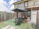 Fenced backyard with patio, umbrella and green space offers relaxation and privacy at 57 Trails End St, Greenwood, IN 46142