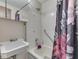 A bathroom with a shower and tub combination, a floral shower curtain, and a sink at 57 Trails End St, Greenwood, IN 46142
