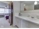 A bright bathroom with a vanity, a sink, and a view of an adjoining bedroom at 57 Trails End St, Greenwood, IN 46142