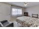 A bright bedroom with a large window, ceiling fan, and comfy chair offers a relaxing space at 57 Trails End St, Greenwood, IN 46142