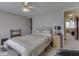 A cozy bedroom featuring neutral walls, a ceiling fan, and a comfortable bed with floral-patterned bedding at 57 Trails End St, Greenwood, IN 46142