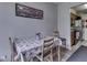 Cozy dining area featuring wood chairs, floral tablecloth, and adjacent kitchen, perfect for intimate meals at 57 Trails End St, Greenwood, IN 46142