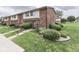 Charming townhouse featuring brick accents, well-kept landscaping, and inviting front entrance at 57 Trails End St, Greenwood, IN 46142