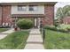 Charming townhouse with brick accents, lawn, and inviting walkway creating curb appeal at 57 Trails End St, Greenwood, IN 46142