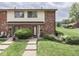 Charming townhome with brick facade, manicured lawn, and inviting entrance at 57 Trails End St, Greenwood, IN 46142